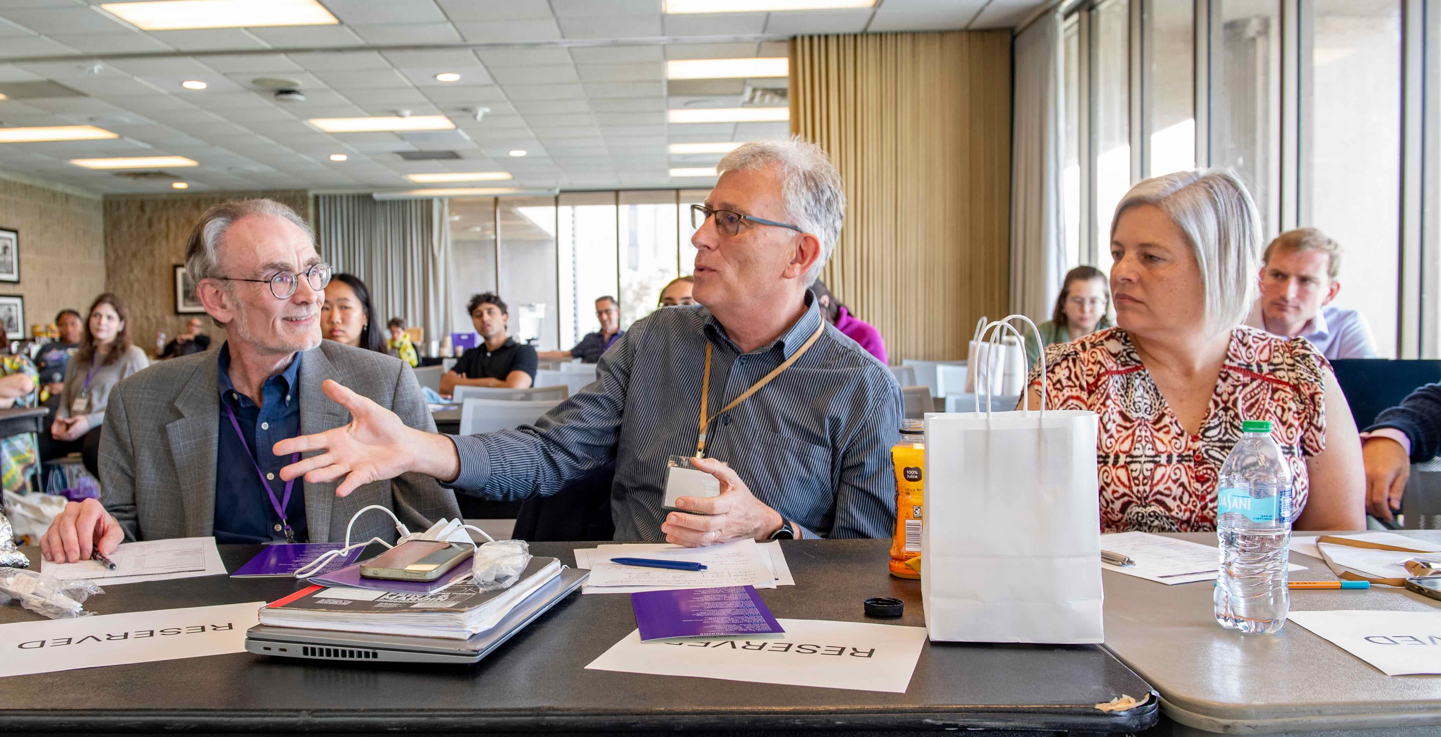 A panel of three judges watch a presentation