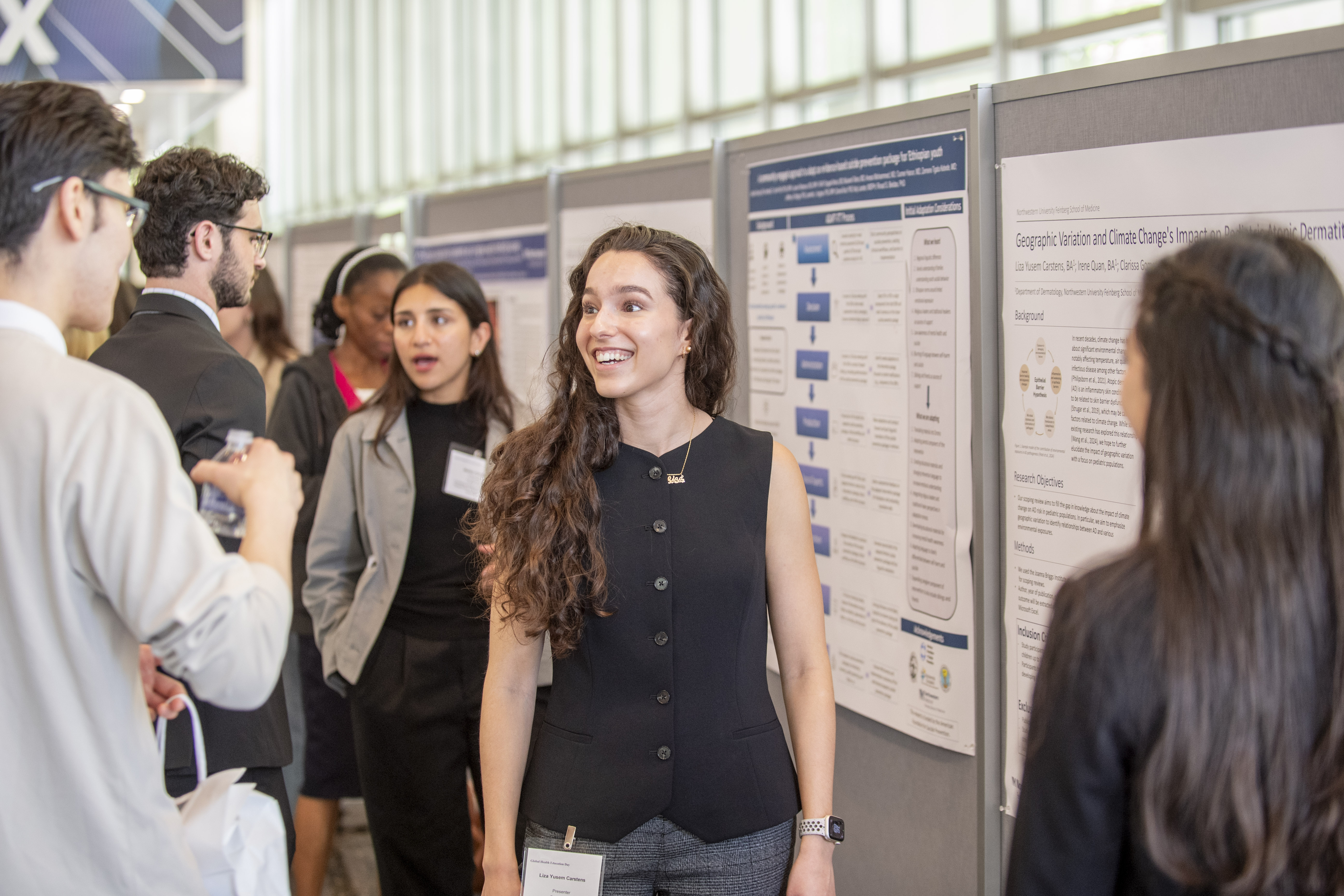 Presenters discuss their posters at Global Health Education Day