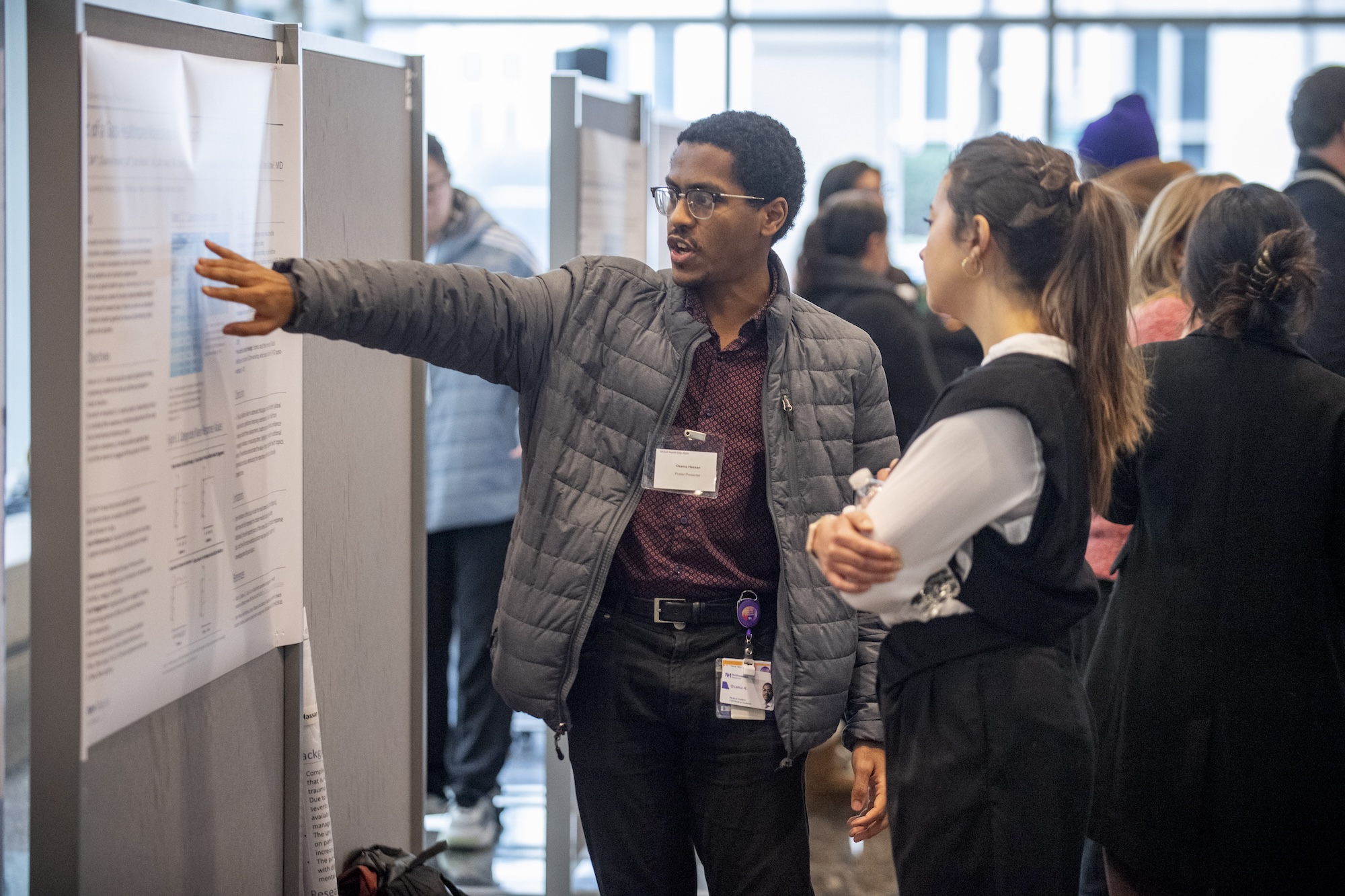 Global Health Day participants presenting their poster to a judge