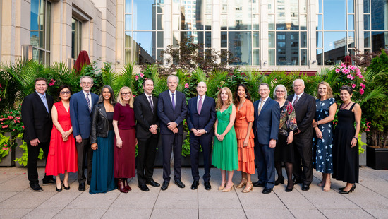 IGH leadership posing in a line outside on a terrace