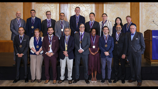 Faculty standing with honorific medals around their neck at the investiture ceremony