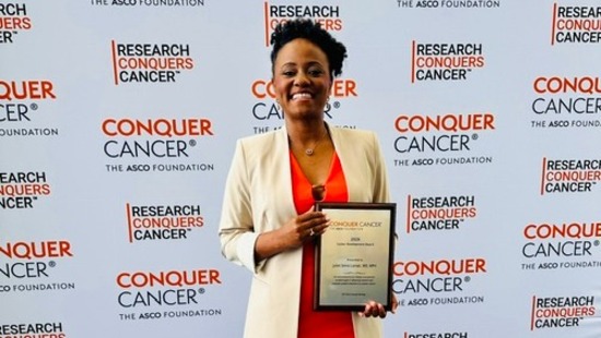 Juliet Lumati holding an ASCO Award plaque