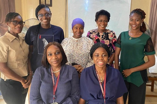 A group of seven colleagues sitting and standing together