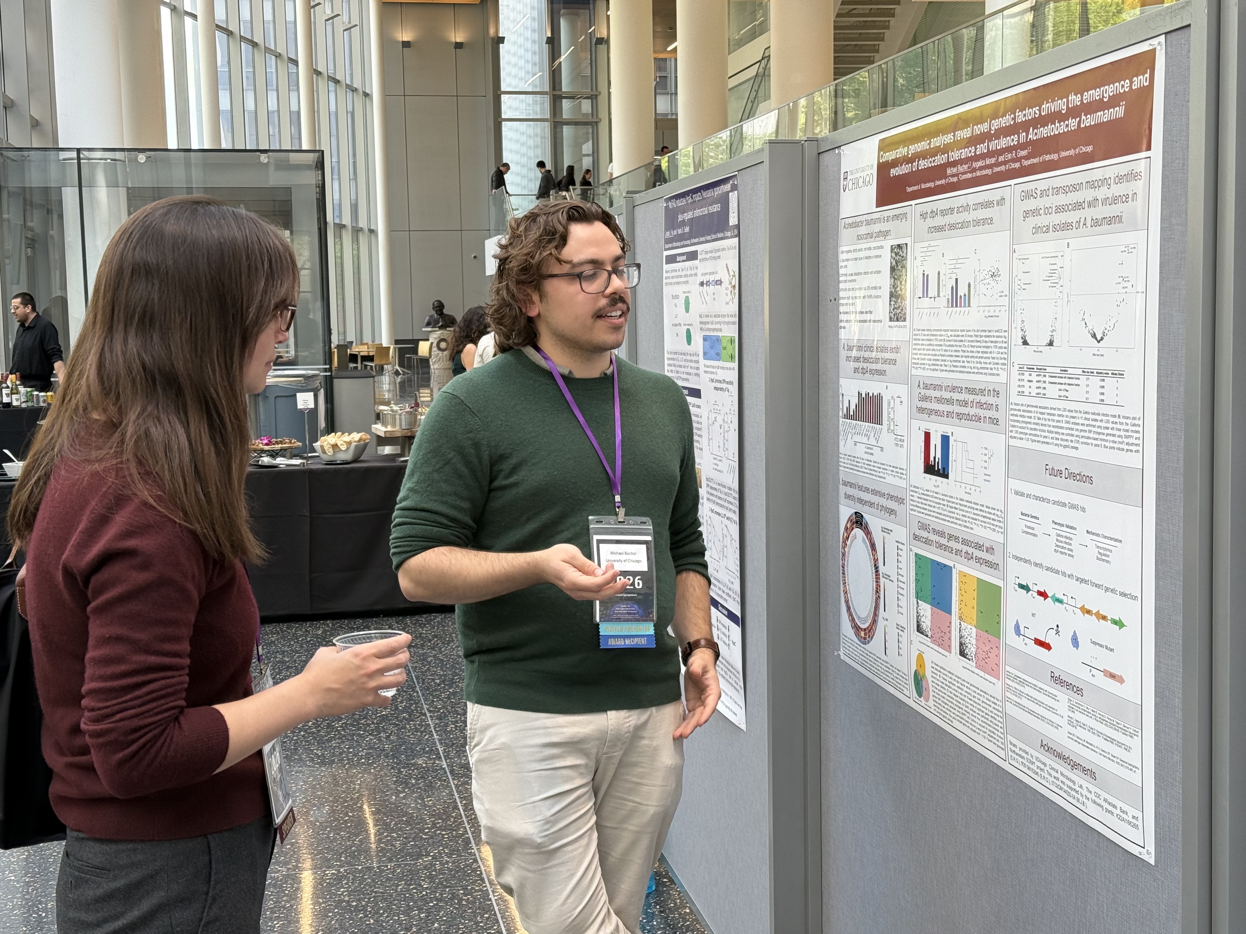 Two presenters talking at a poster session