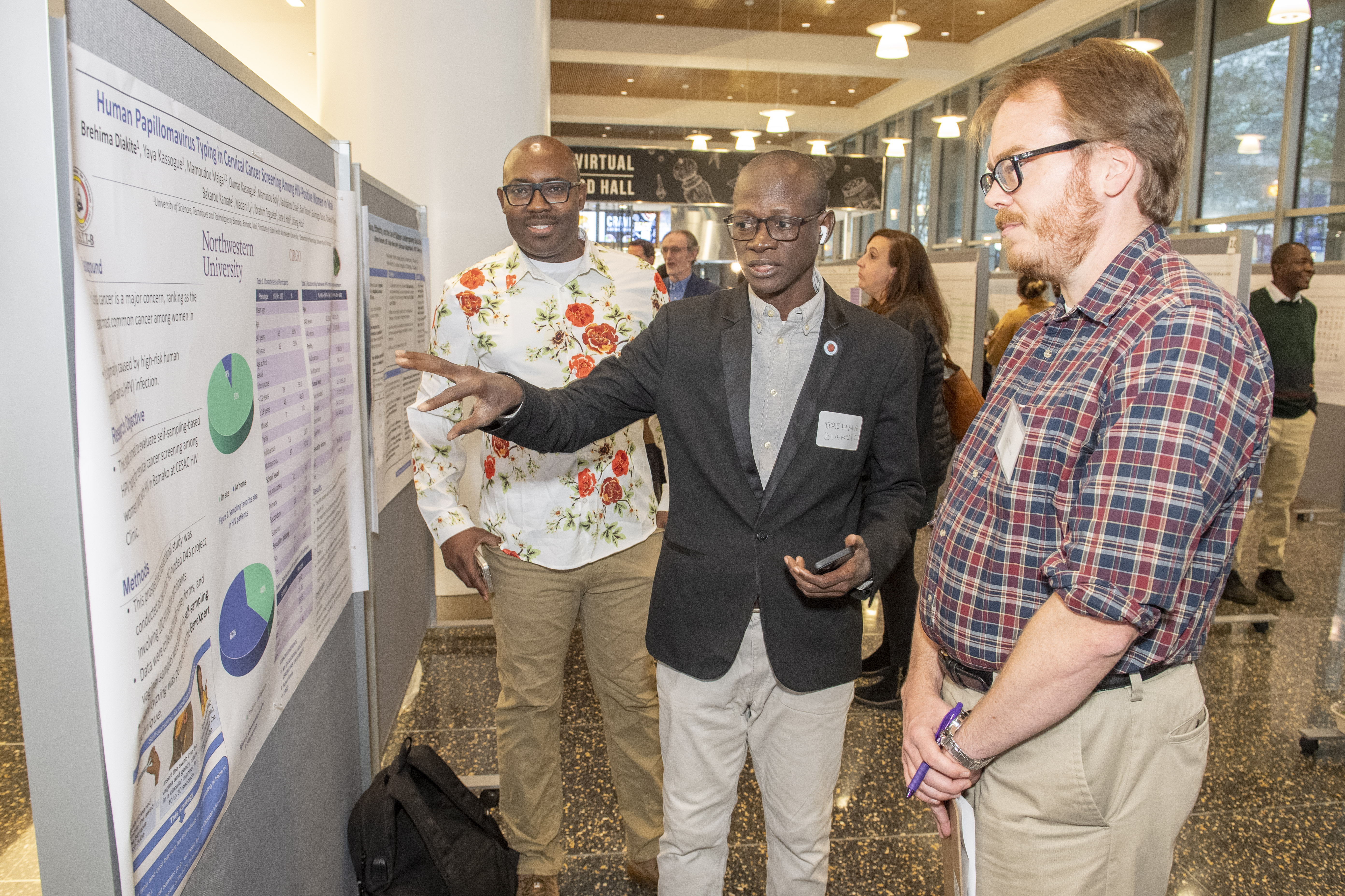 Global Health Day participants presenting their poster to a judge