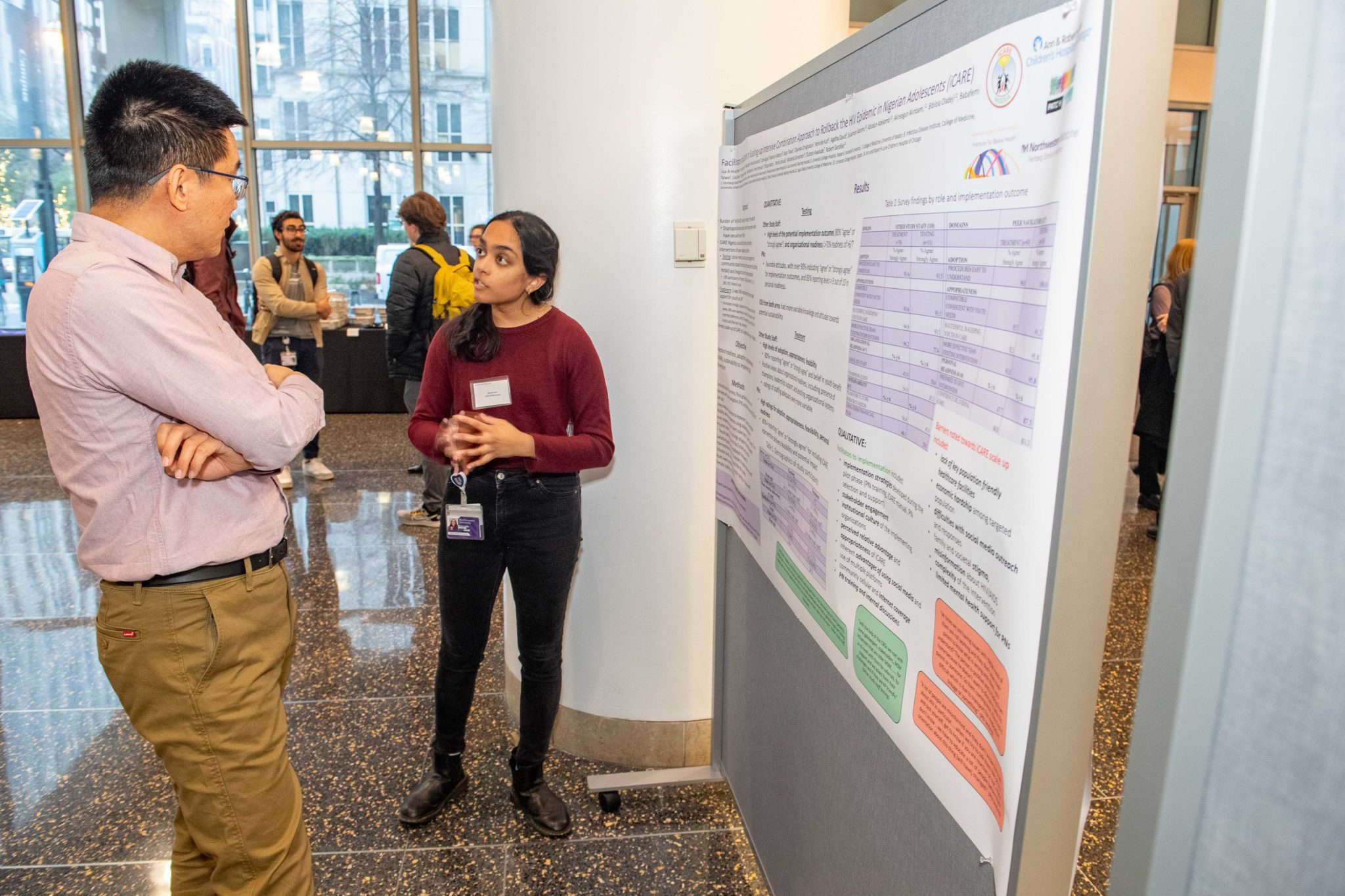 Global Health Day presenter discussing their poster with a judge